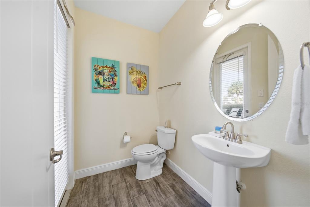 8017 Surf Street Kissimmee, FL 34747 - Photo 6 of 64 a bathroom with a toilet sink and mirror