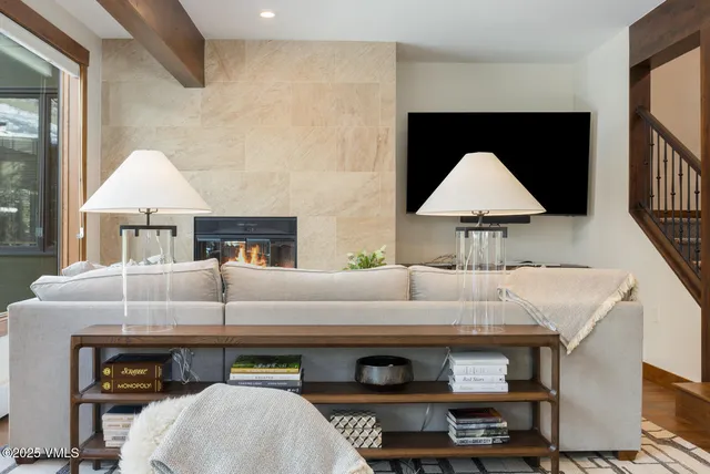 a living room with furniture and a lamp