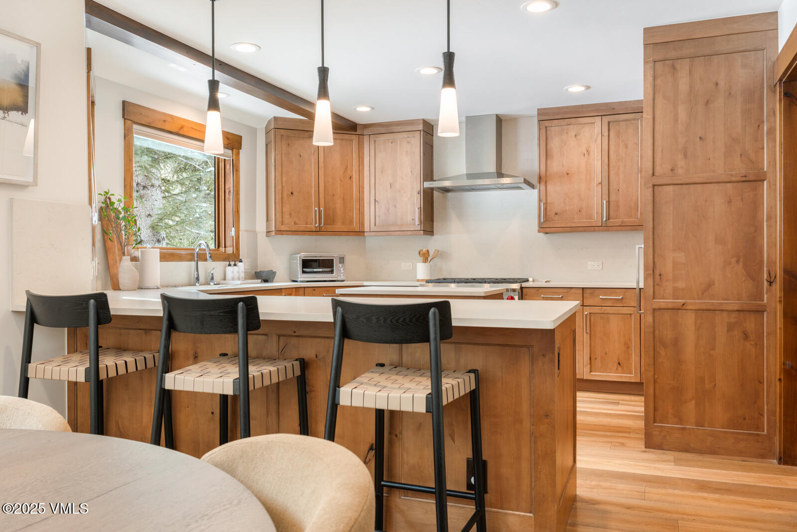 1670 Fallridge Place, Unit C11 Vail, CO 81657 - Photo 3 of 39 a kitchen with stainless steel appliances a refrigerator a sink a stove a dining table and chairs