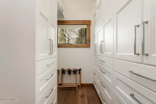 a view of a bedroom with wooden floor and cabinet