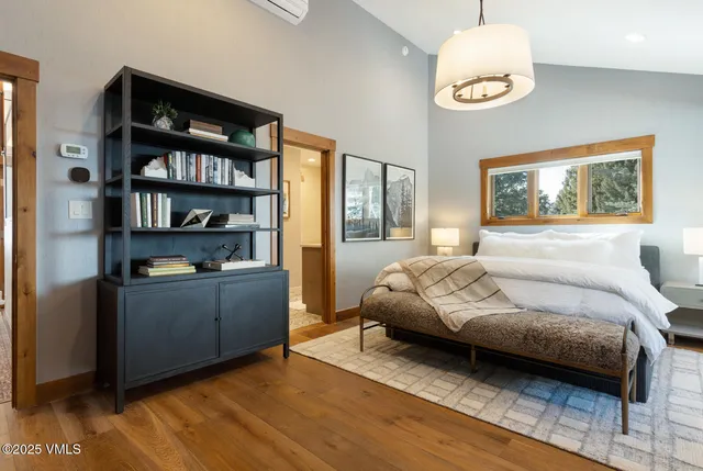 a bedroom with a bed and a chandelier