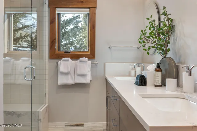 a bathroom with a tub sink and mirror