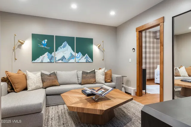 a living room with furniture and a painting