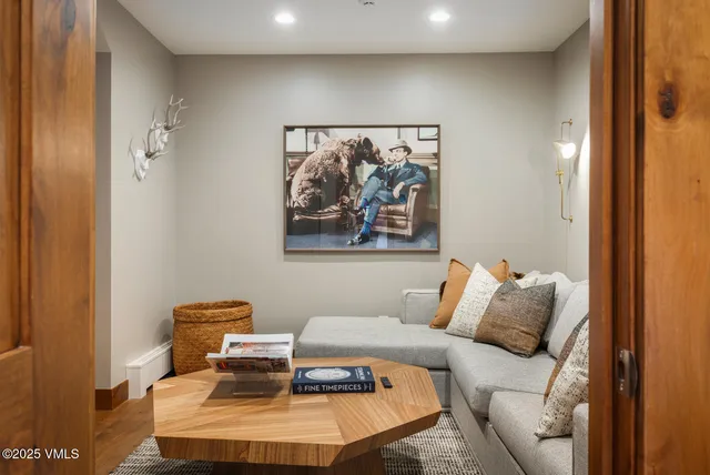 a bedroom with a bed and painting on the wall