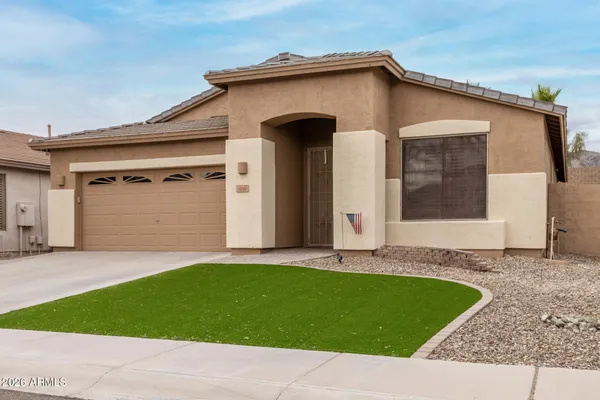 a front view of a house with a yard and garage