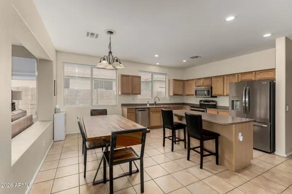 a kitchen with stainless steel appliances kitchen island granite countertop a sink and cabinets