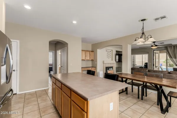 a view of a kitchen with granite countertop a table and chairs in it