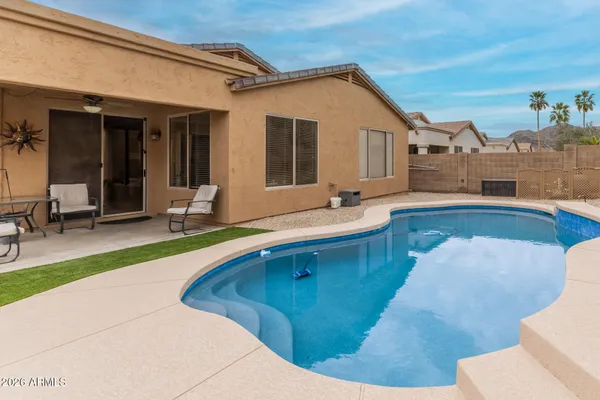 a swimming pool with outdoor seating