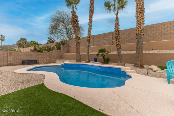 a swimming pool with outdoor seating