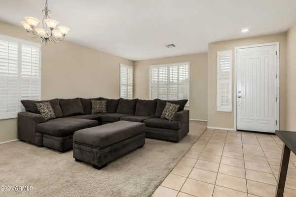 a living room with furniture and a chandelier