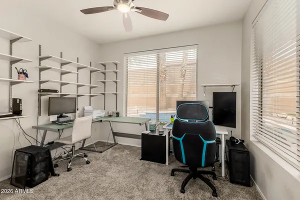 a view of a workspace with furniture and a window