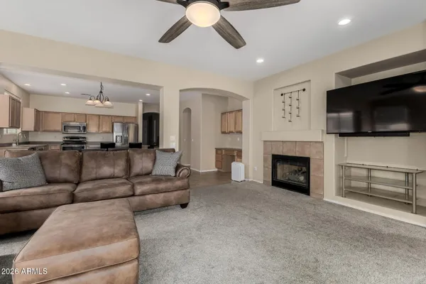 a living room with furniture a flat screen tv and a fireplace