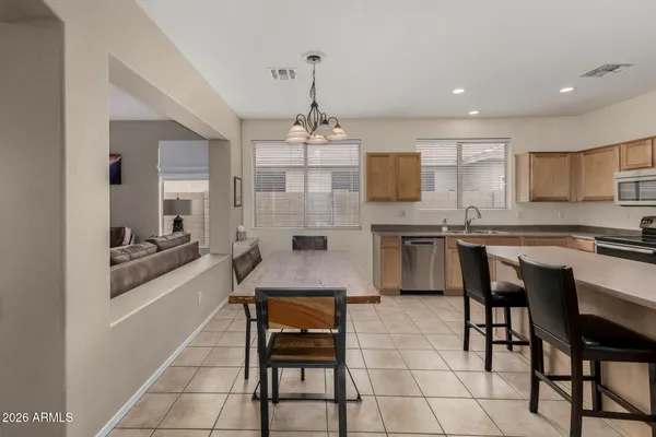 a large kitchen with a table and chairs in it