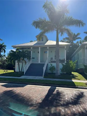 a front view of a house with a yard and a garage