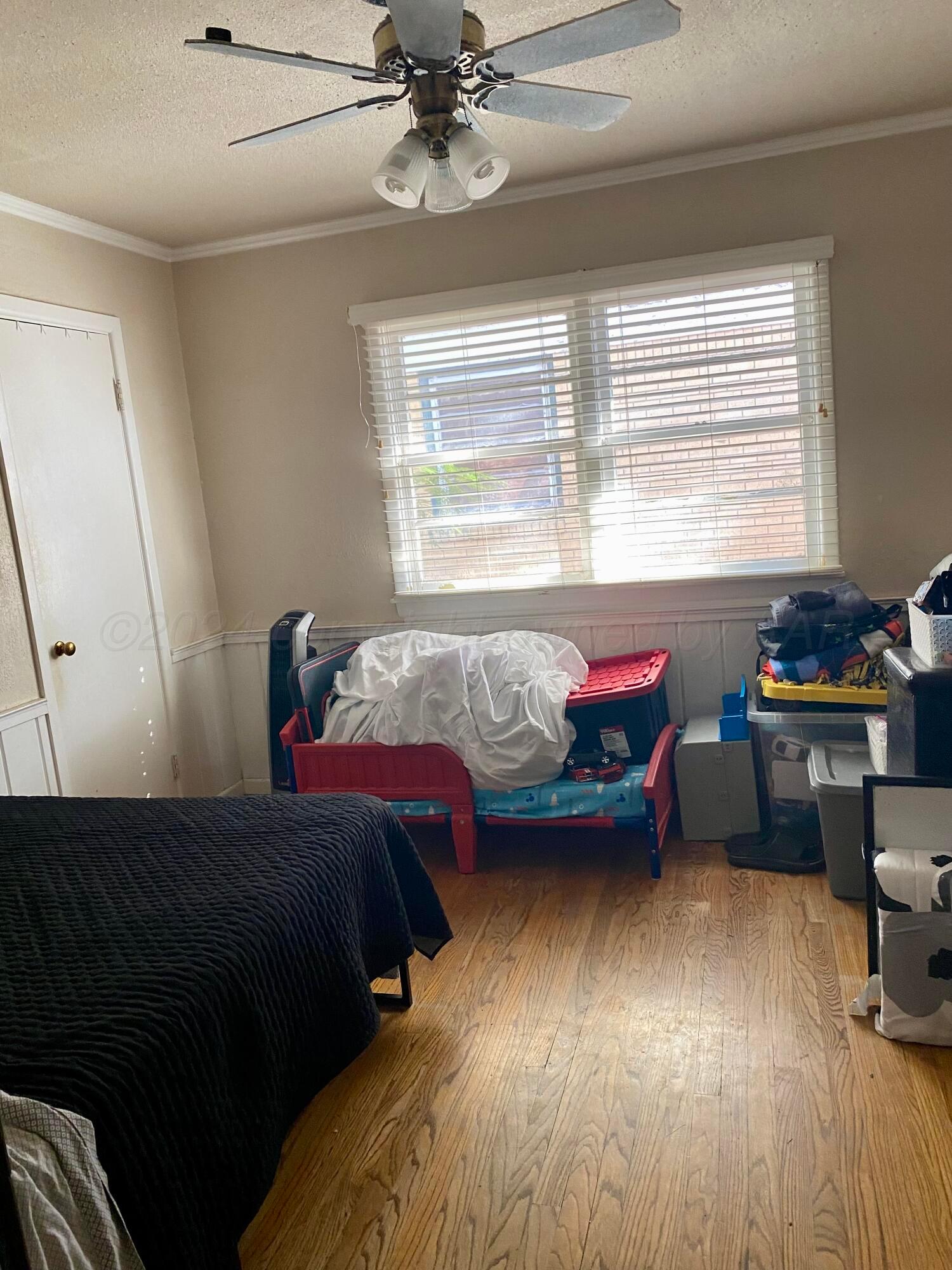 3309 Paramount Boulevard Amarillo, TX 79109 - Photo 12 of 26 a bedroom with a bed and a window