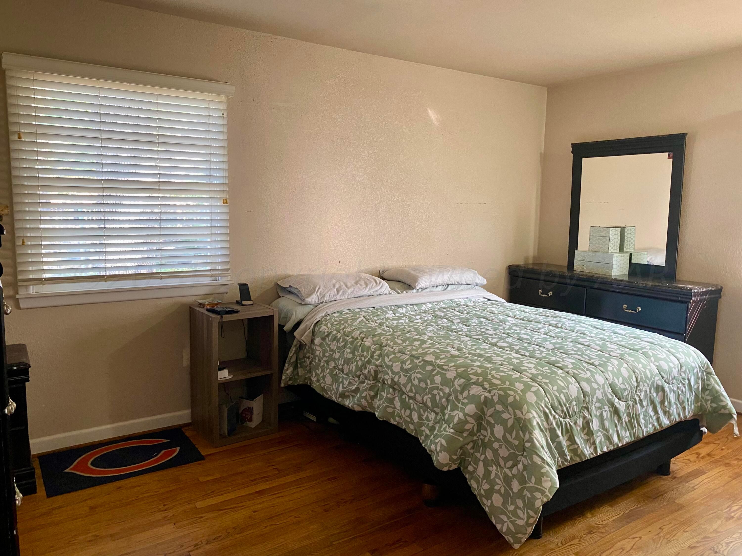 3309 Paramount Boulevard Amarillo, TX 79109 - Photo 14 of 26 a bedroom with a bed and a window