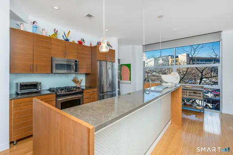 a kitchen with stainless steel appliances granite countertop a stove and a refrigerator