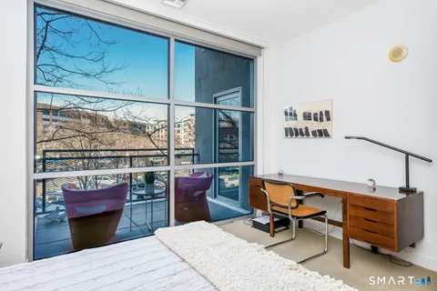 a bedroom with furniture and a window