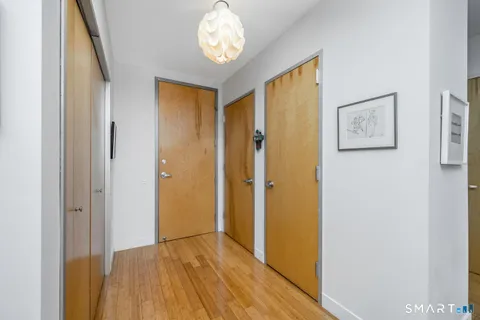 a view of an empty room with wooden floor