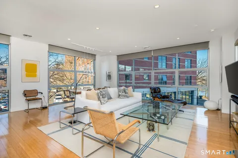 a living room with fireplace furniture and a flat screen tv