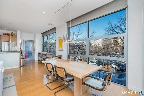 a view of a dining room with furniture window and outside view