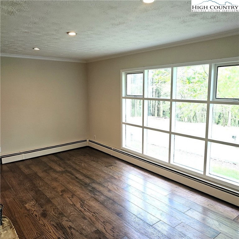 139 Charles Street Boone, NC 28607 - Photo 16 of 49 a view of an empty room with wooden floor and a window