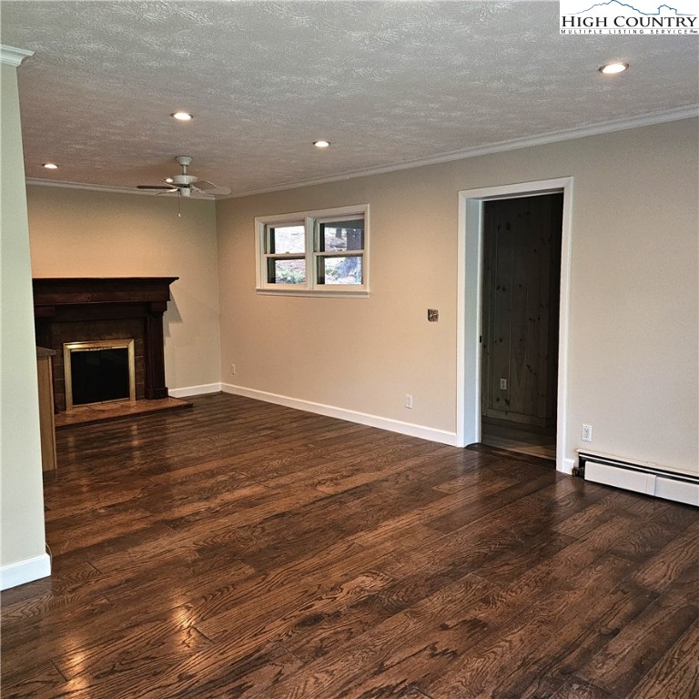 139 Charles Street Boone, NC 28607 - Photo 17 of 49 an empty room with wooden floor and a fireplace