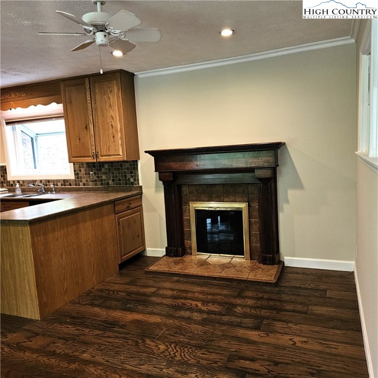 139 Charles Street Boone, NC 28607 - Photo 19 of 49 a kitchen with granite countertop wooden floors and a fireplace