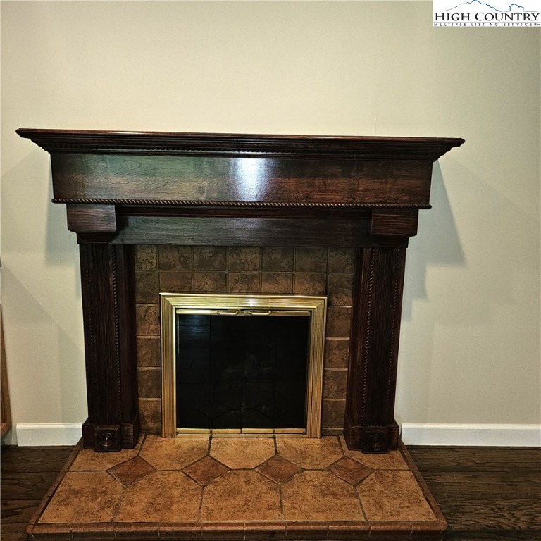 139 Charles Street Boone, NC 28607 - Photo 20 of 49 a fireplace with a clock on wooden floor