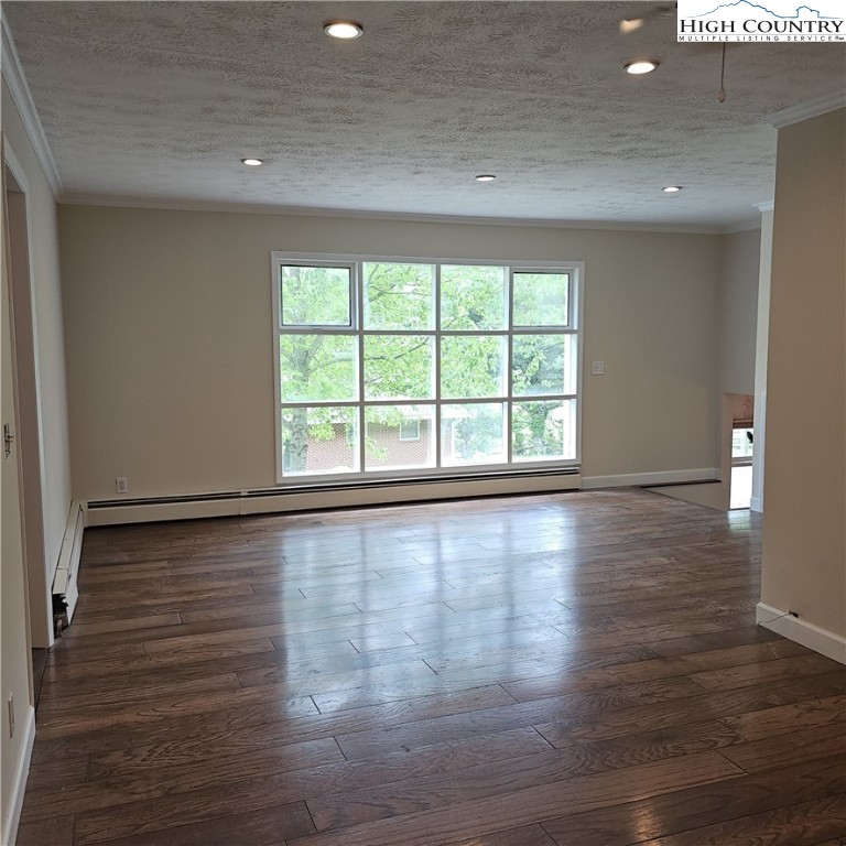 139 Charles Street Boone, NC 28607 - Photo 24 of 49 a view of an empty room with wooden floor and a window