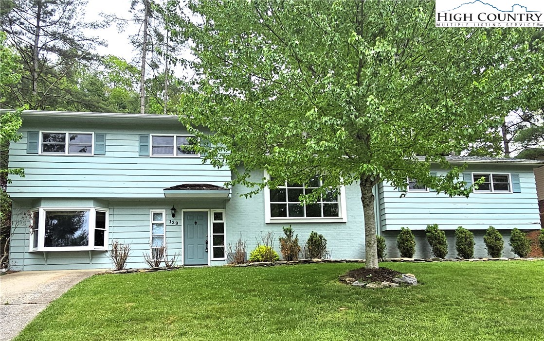 139 Charles Street Boone, NC 28607 - Photo 4 of 49 a front view of a house with a garden