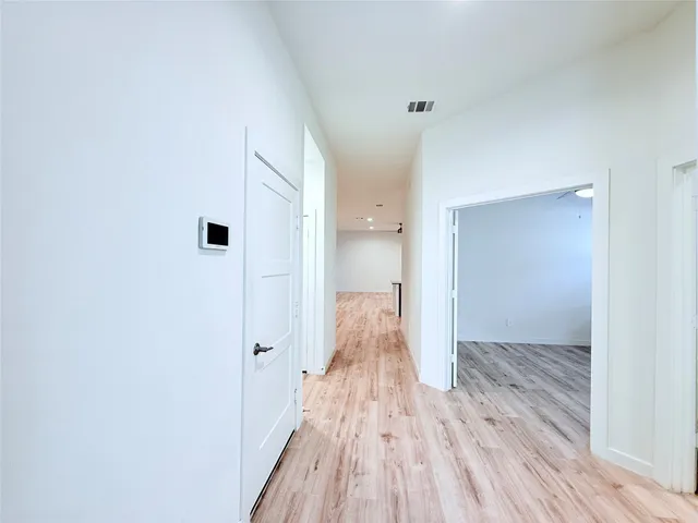 a view of a room with wooden floor
