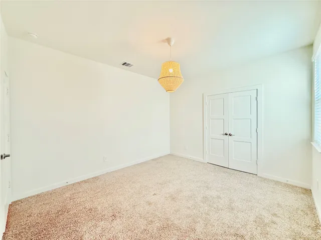 a view of a room with wooden floor and ceiling fan