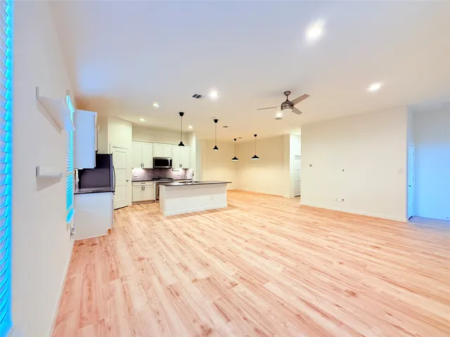 a view of kitchen with sink and natural light