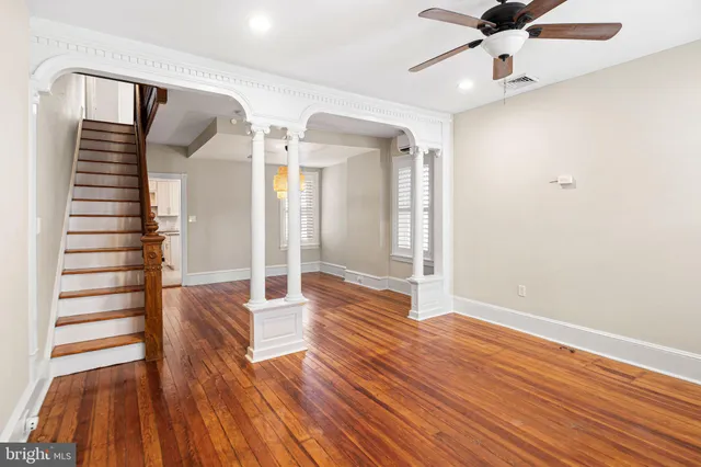wooden floor in an empty room with a window