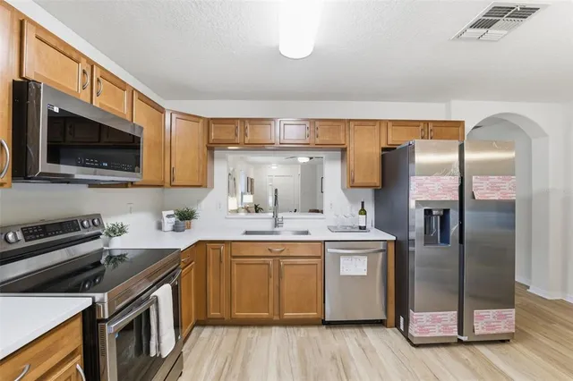 a kitchen with a sink stove and refrigerator