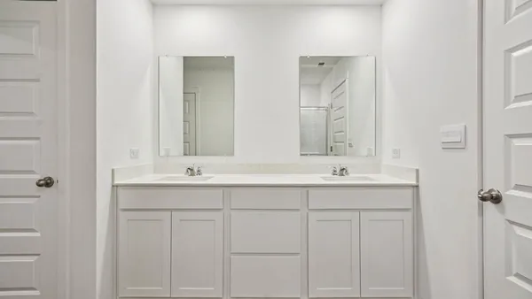 a bathroom with a granite countertop toilet and a sink
