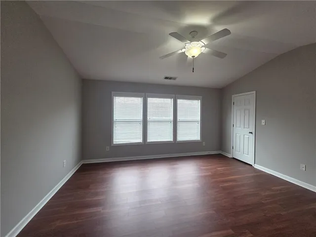 a spacious bathroom with a tub sink and a mirror