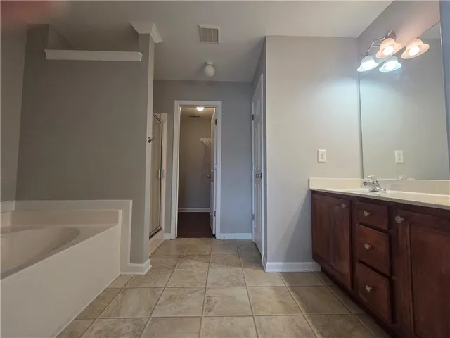 a bathroom with a double vanity sink and a mirror
