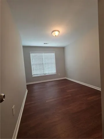 a bathroom with a toilet a sink a mirror and vanity