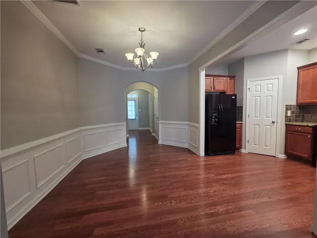 a kitchen with stainless steel appliances kitchen island granite countertop a stove a sink dishwasher and a refrigerator