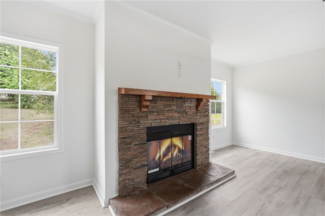 112 Sir Francis Drake Way Liberty, SC 29657 - Photo 27 of 42 This living area features a warm fireplace, perfect for cozy evenings.