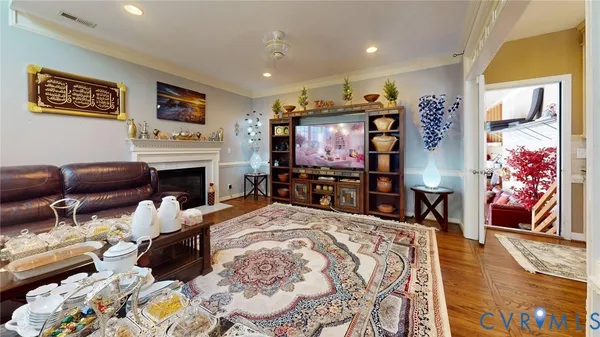 a view of empty room with wooden floor and fireplace