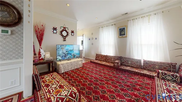 a dining room with wooden floor a chandelier a wooden table and chairs