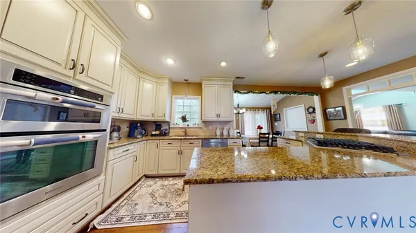 a large kitchen with kitchen island granite countertop a large counter top appliances and a sink