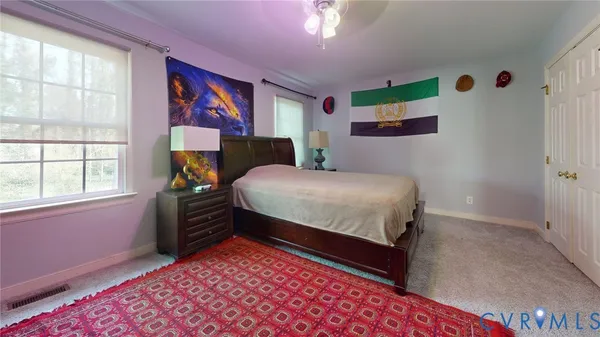 a bedroom with a bed and a couch