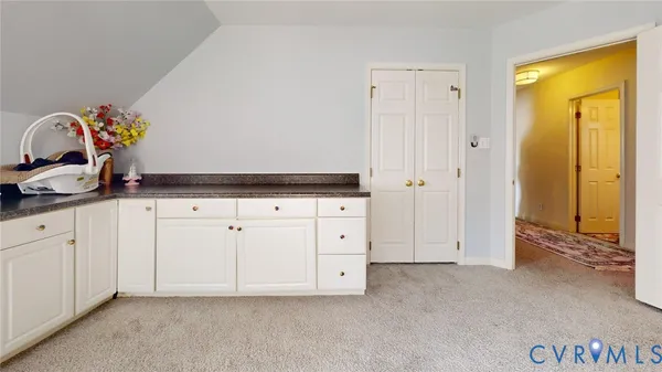 a view of a kitchen with a sink and dishwasher stove top oven with wooden floor