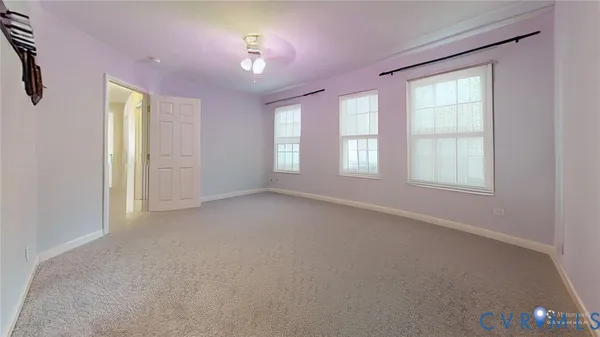 an empty room with windows and closet