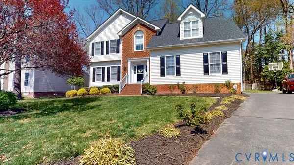 a view of a house with a small yard and wooden fence