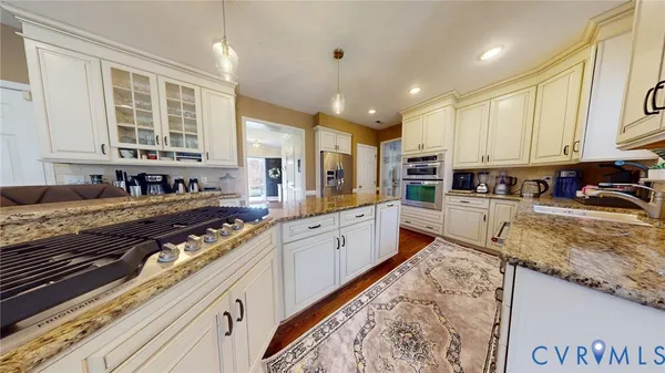 a kitchen with stainless steel appliances granite countertop a sink and cabinets
